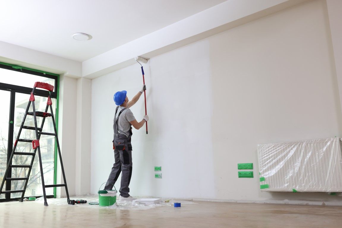 Painter cutting a clean edge along a ceiling line