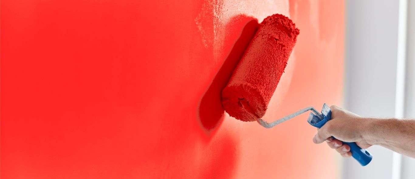 Close-up of a freshly painted trim board with a sharp paint line